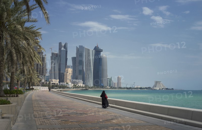 Woman walking on Doha waterfront