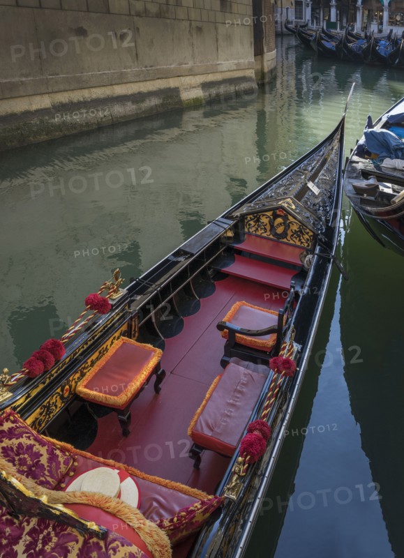 Empty gondola sailing on Venice canal