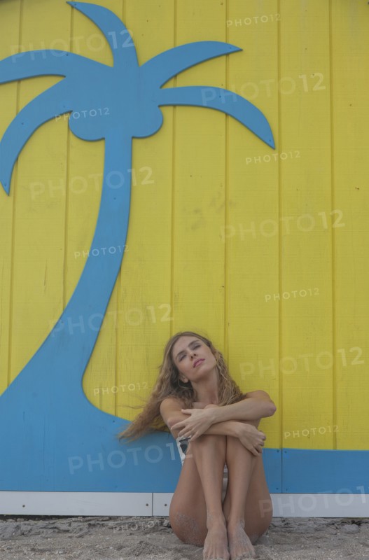 Caucasian woman sitting near wall