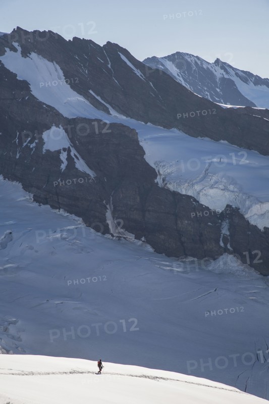 Hiker on snowy mountain slopes
