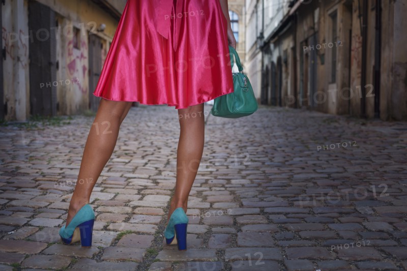 Caucasian woman wearing heels in alleyway