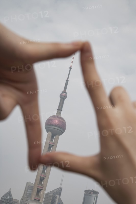 Chinese woman framing Shanghai tower