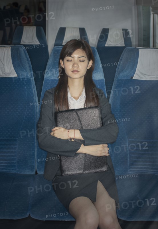 Chinese businesswoman napping on airplane