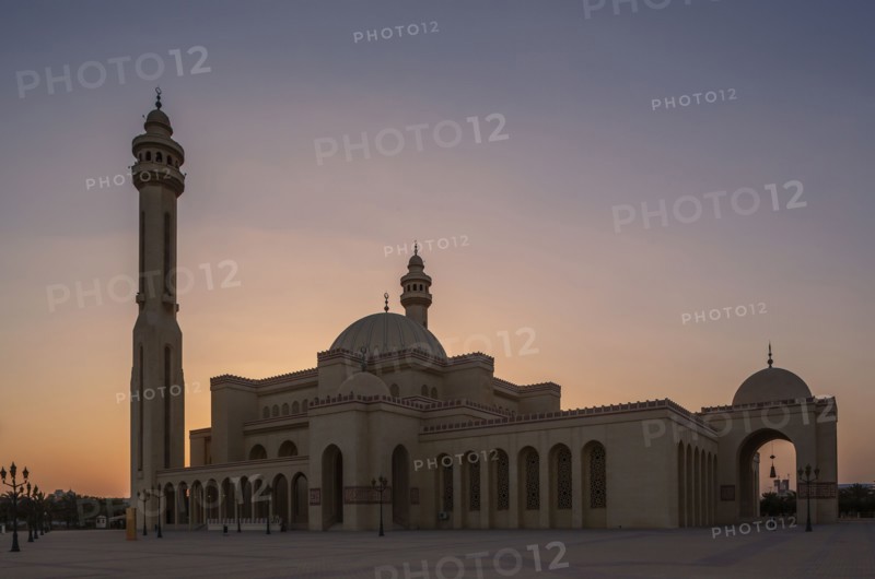 Mosque and tower under sunset sky