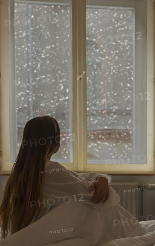 Caucasian woman looking out window
