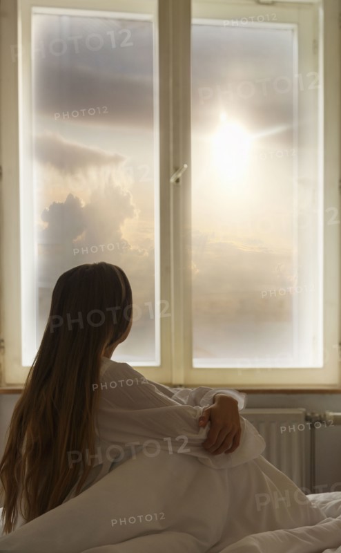 Caucasian woman looking out window