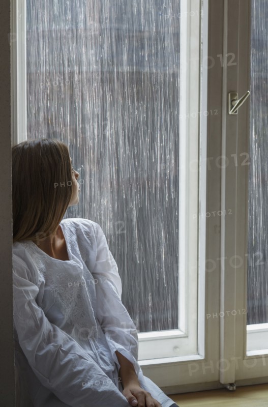 Caucasian woman looking out window