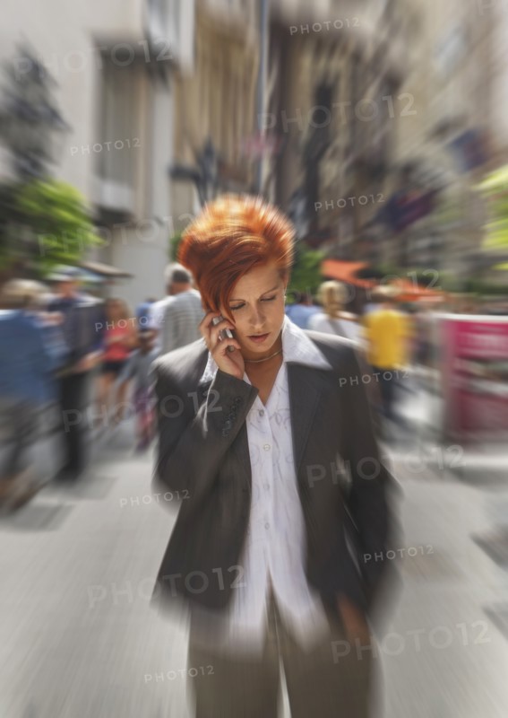 Caucasian businesswoman talking on cell phone in city