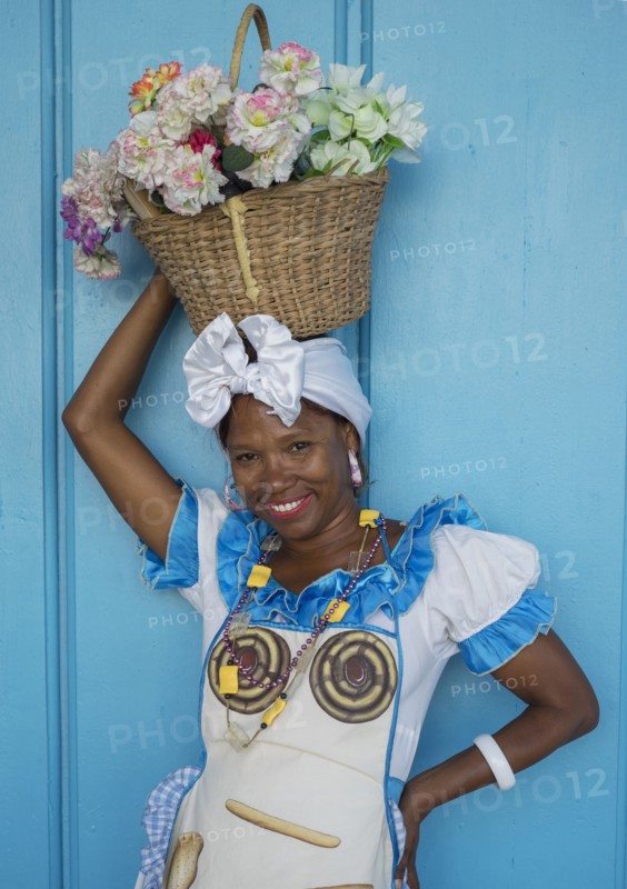 Black woman balancing basket on her head