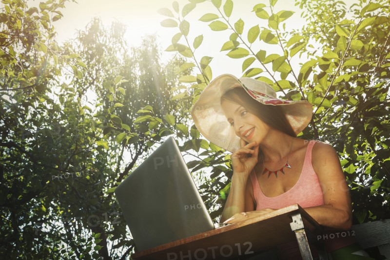 Caucasian woman using laptop outdoors