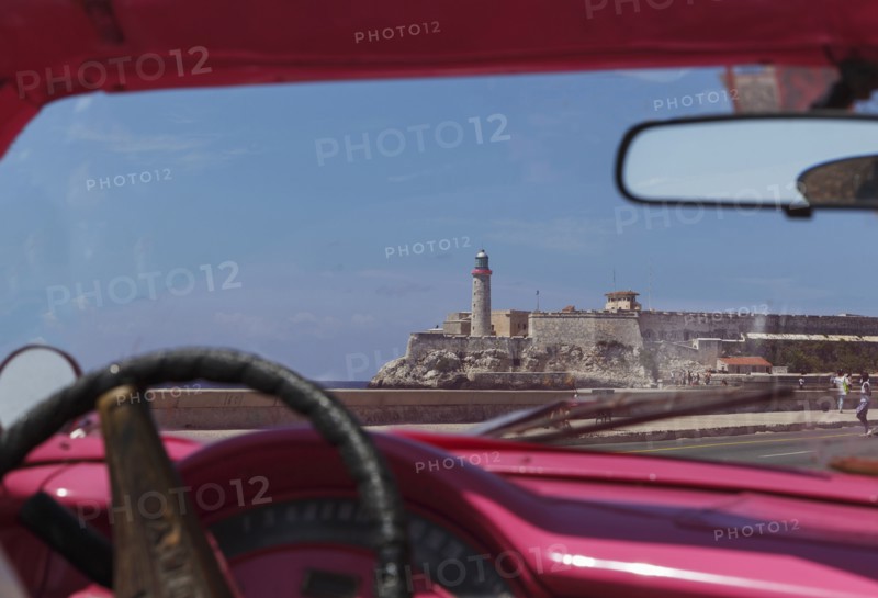 Car driving in Havana cityscape