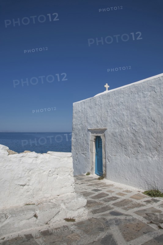 Cross on traditional building under blue sky