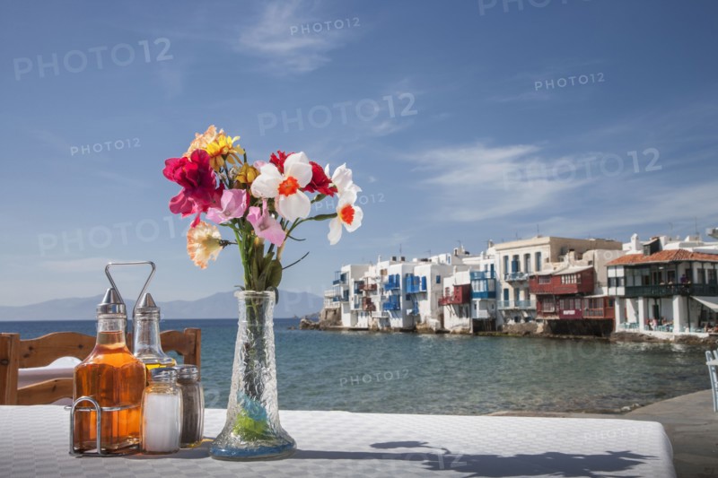 Seasonings and flowers on oceanfront cafe table