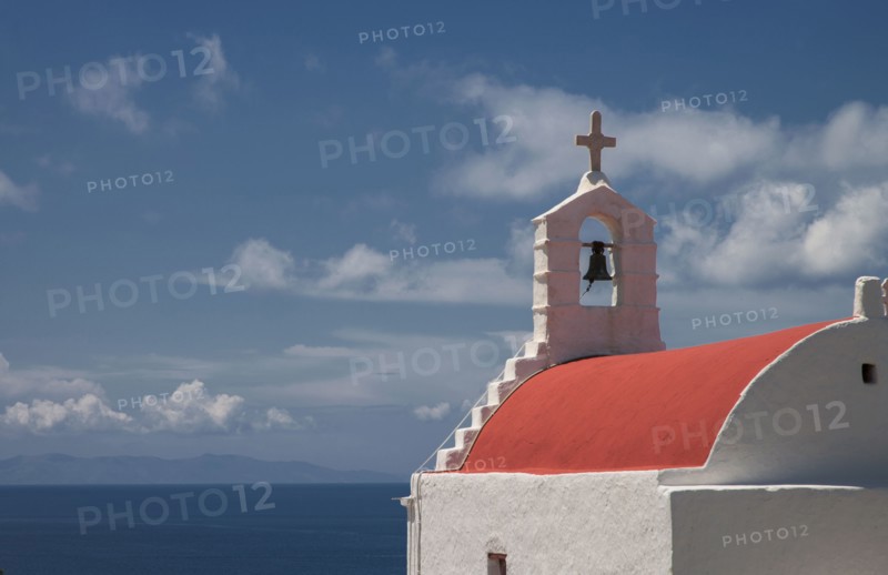 Traditional bell arch and seascape under blue sky