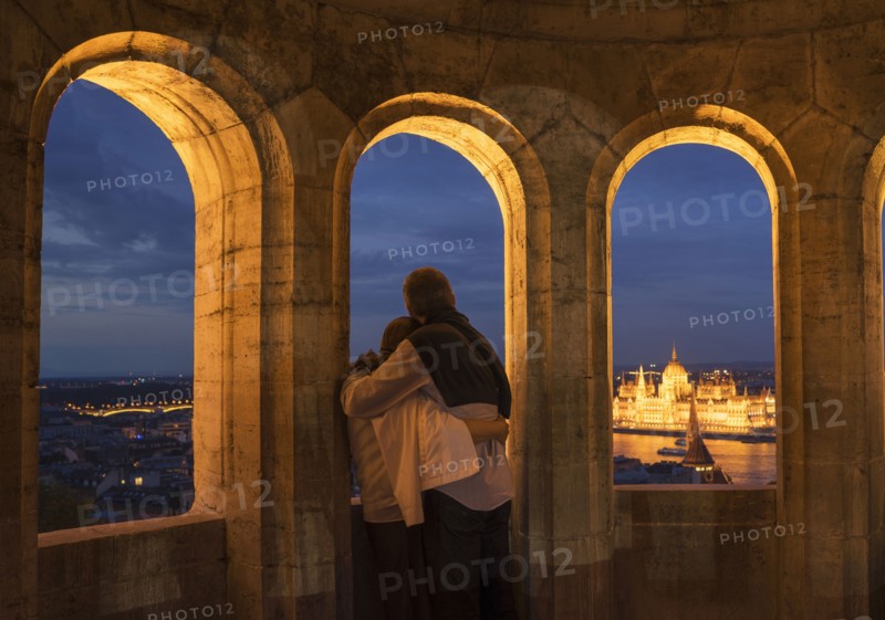 Tourists admiring cityscape from arch