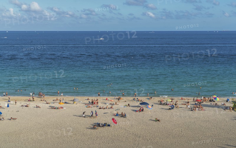 Tourists sunbathing on beach