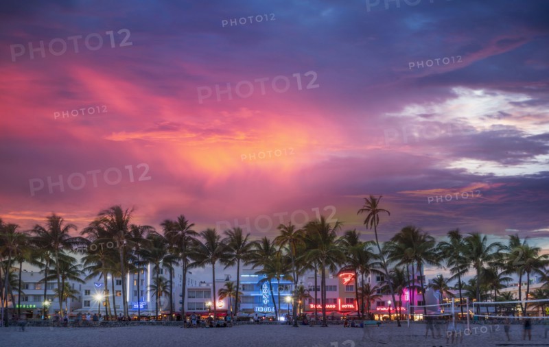 Beachfront buildings under sunset sky