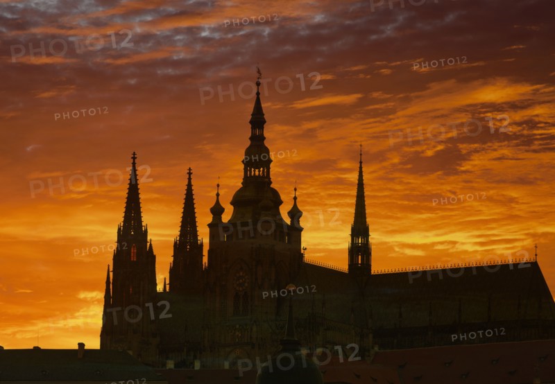 Silhouette of ornate church against sunset sky