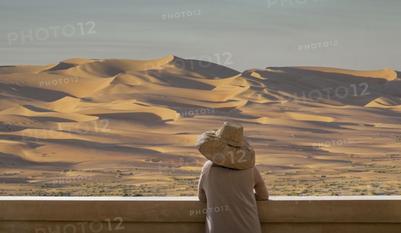 Caucasian woman admiring sand dunes in desert landscape