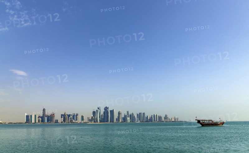 Boat floating near Doha skyline