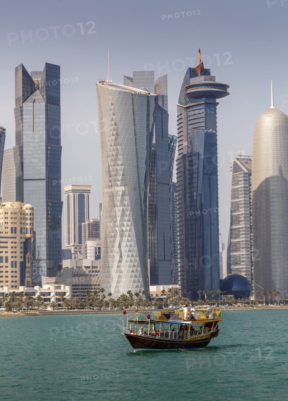 Boat floating near Doha skyline