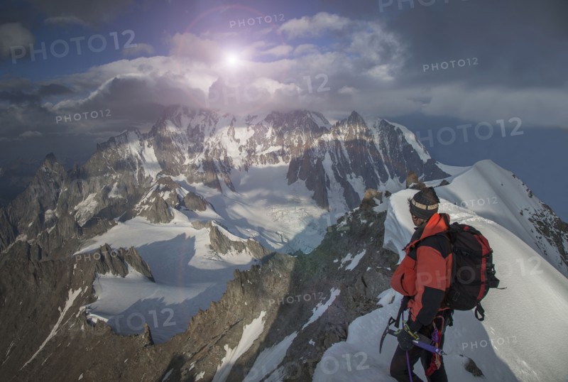 Caucasian climber admiring view from remote mountain top