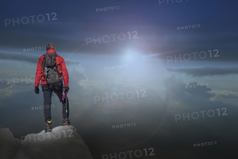 Caucasian hiker standing on mountain top