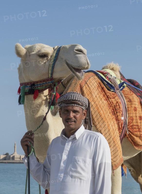 Middle Eastern man with camel near city