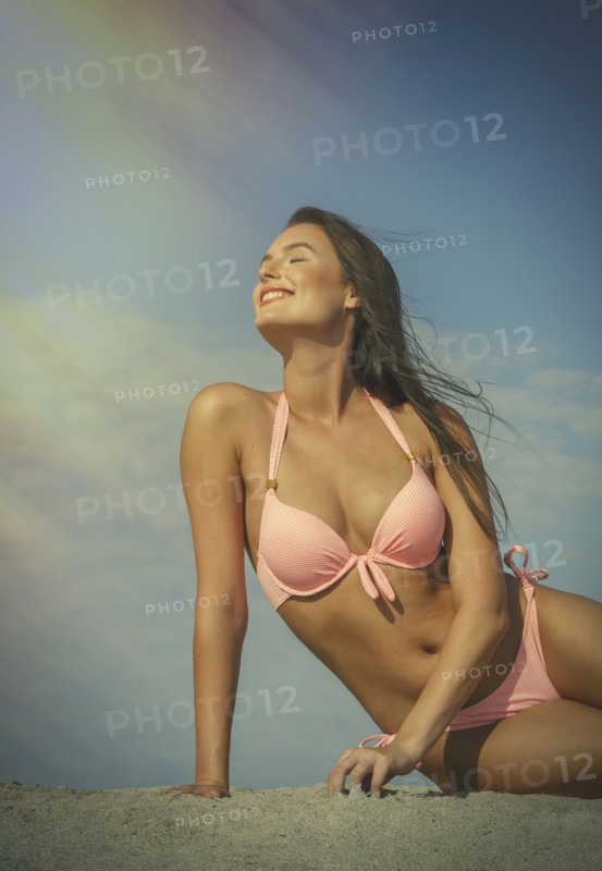 Caucasian woman in pink bikini at beach