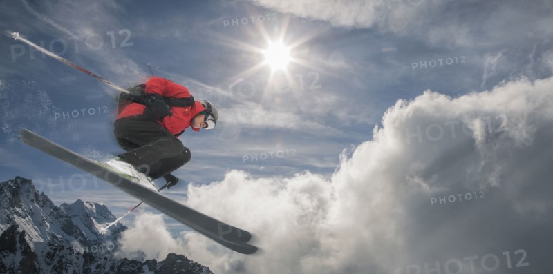 Caucasian skier jumping mid-air on mountain