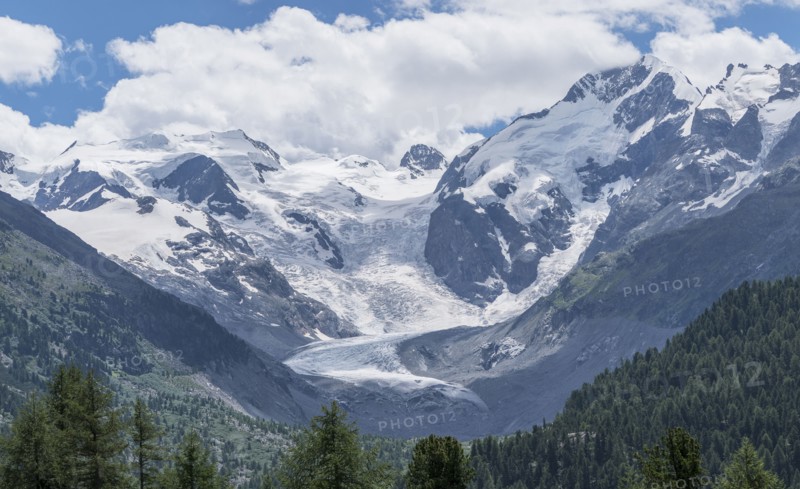 Clouds over snowy mountain range
