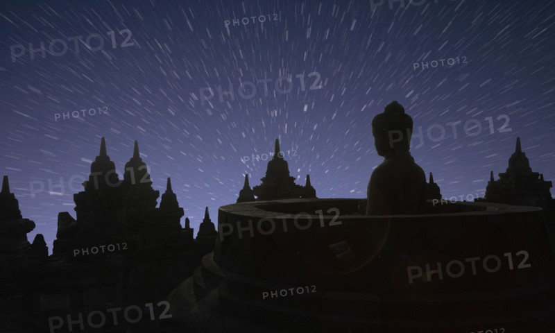 Silhouette of statue of Buddha at sunset