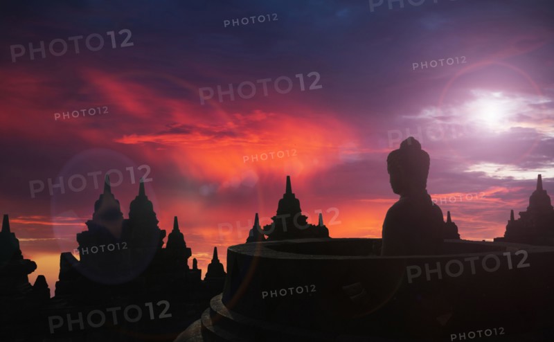Silhouette of statue of Buddha at sunset