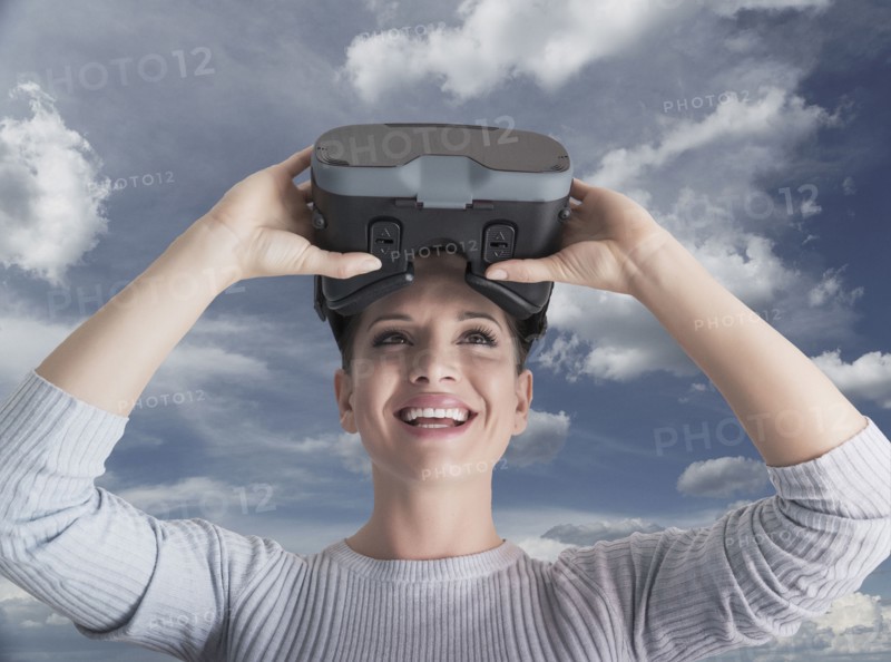 Caucasian woman removing virtual reality goggles