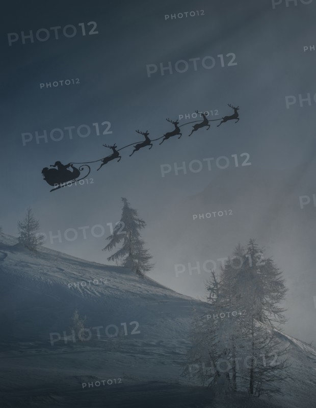 Silhouette of Santa and reindeer flying sleigh in winter
