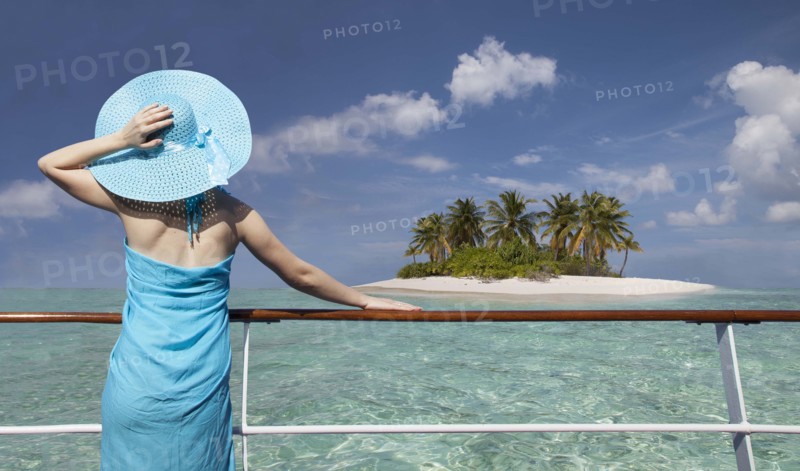 Caucasian woman admiring scenic view of island from boat