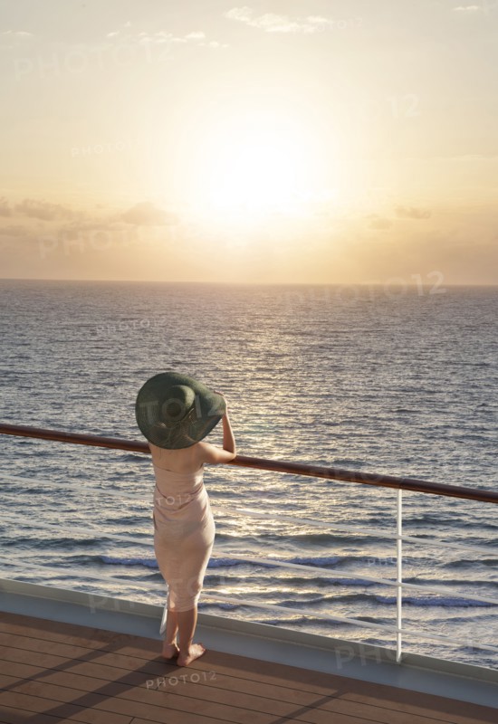 Caucasian woman on boat admiring sunset