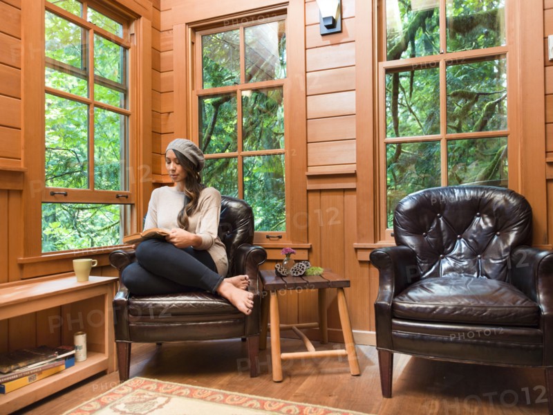 Filipino woman reading in chair