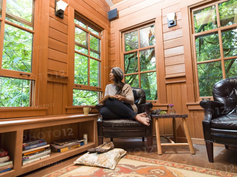 Filipino woman reading in chair