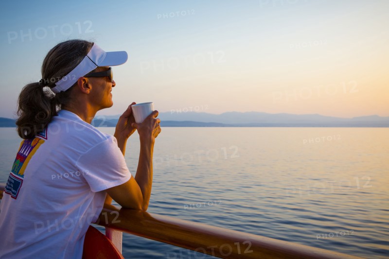 Caucasian woman overlooking ocean from boat deck