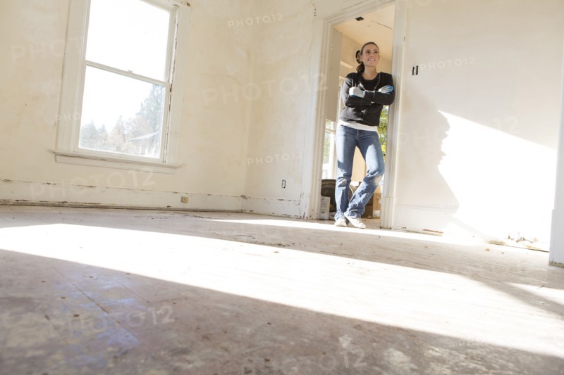 Mixed race woman standing in new home