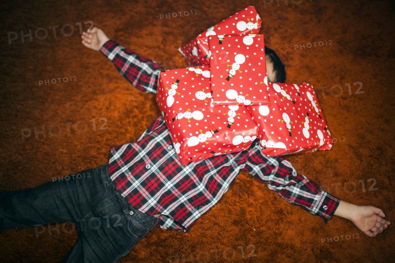 Mixed race boy buried in Christmas gifts