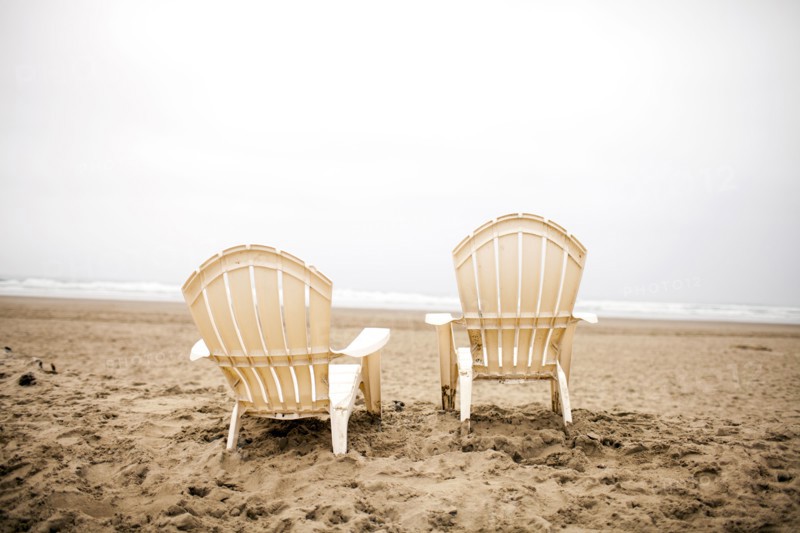 Empty lawn chairs on beach
