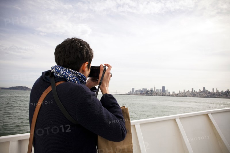 Woman taking picture of city skyline