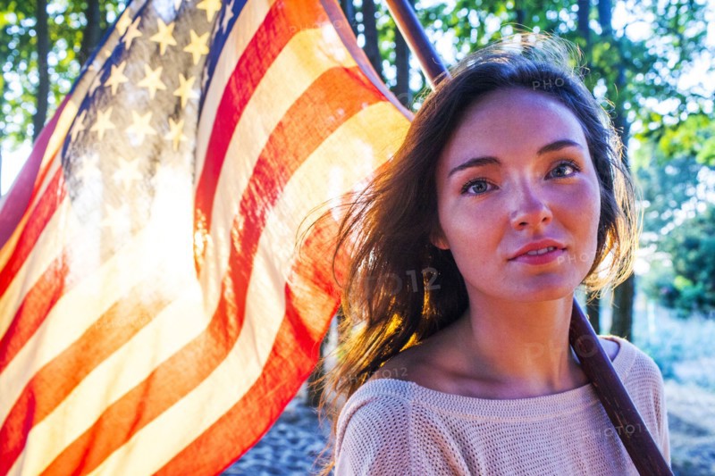 Caucasian woman holding American flag