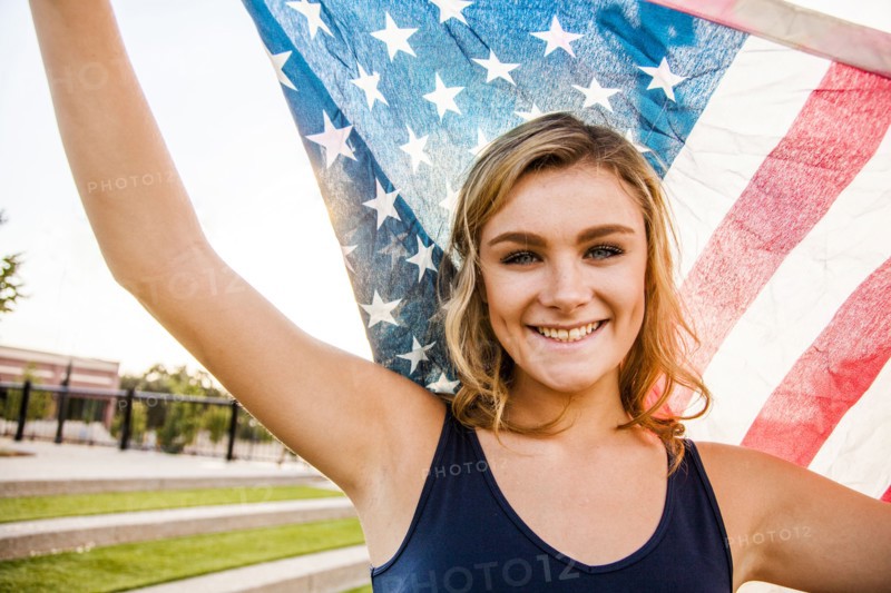 Caucasian teenage girl holding American flag