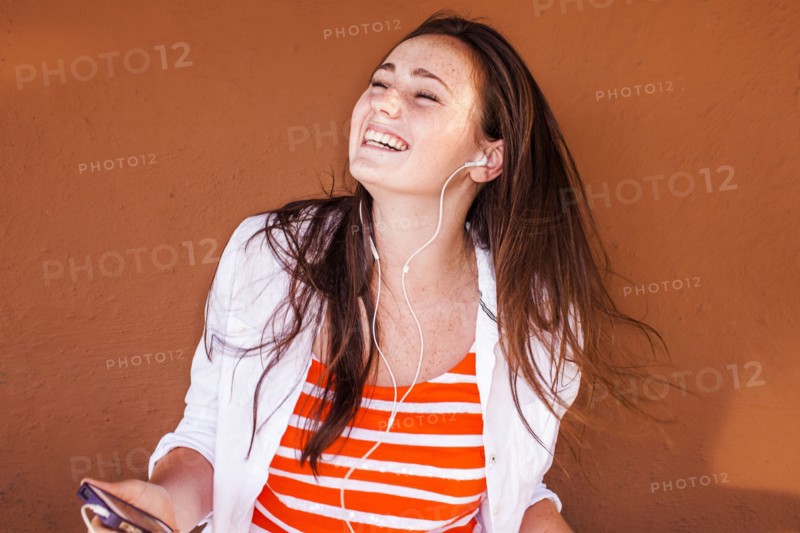 Caucasian woman listening to mp3 player