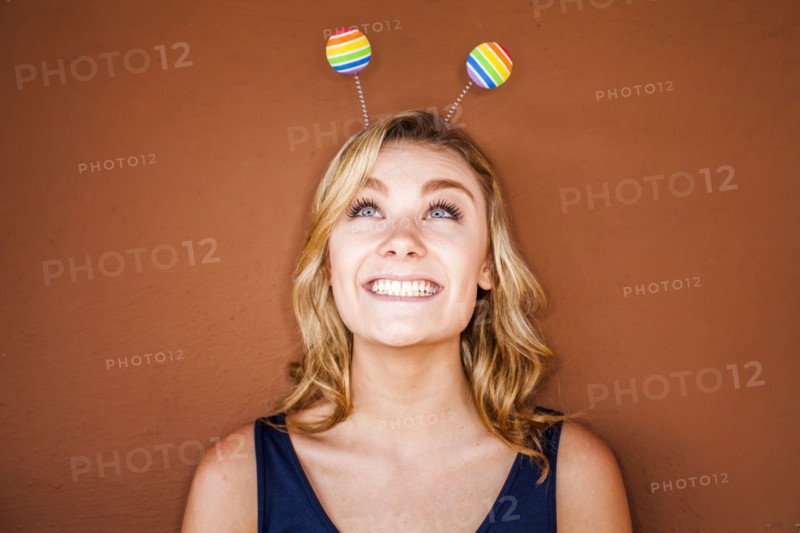 Caucasian teenage girl wearing novelty antenna