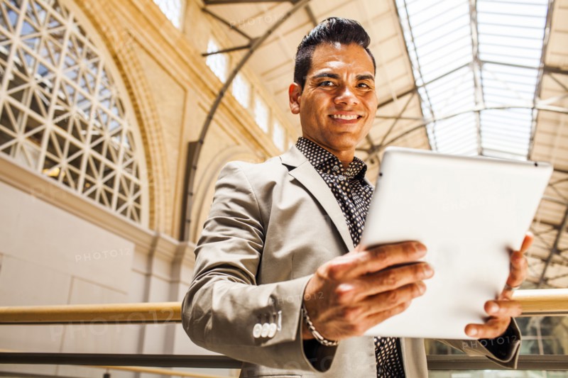 Hispanic businessman using digital tablet