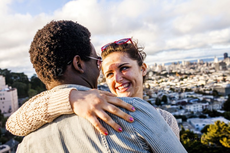 Couple hugging near scenic view of cityscape
